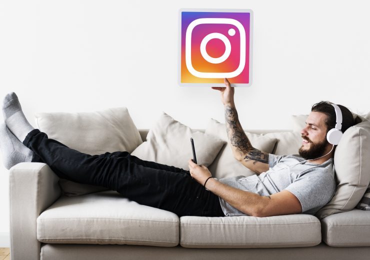 Caucasian man enjoying music at home holding a play button